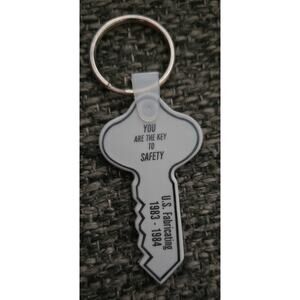 Advertisement Gray Rubbery Keychain US Fabricating You are the Key to SAFETY
